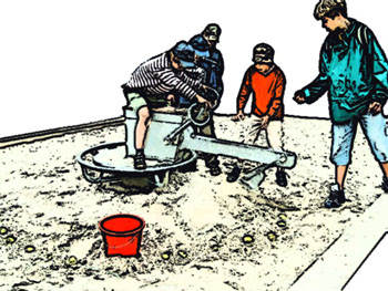Mit Hilfe eines Sandkastenbaggers müssen kleine Bälle im Sand gebaggert und in einen Eimer befördert werden.